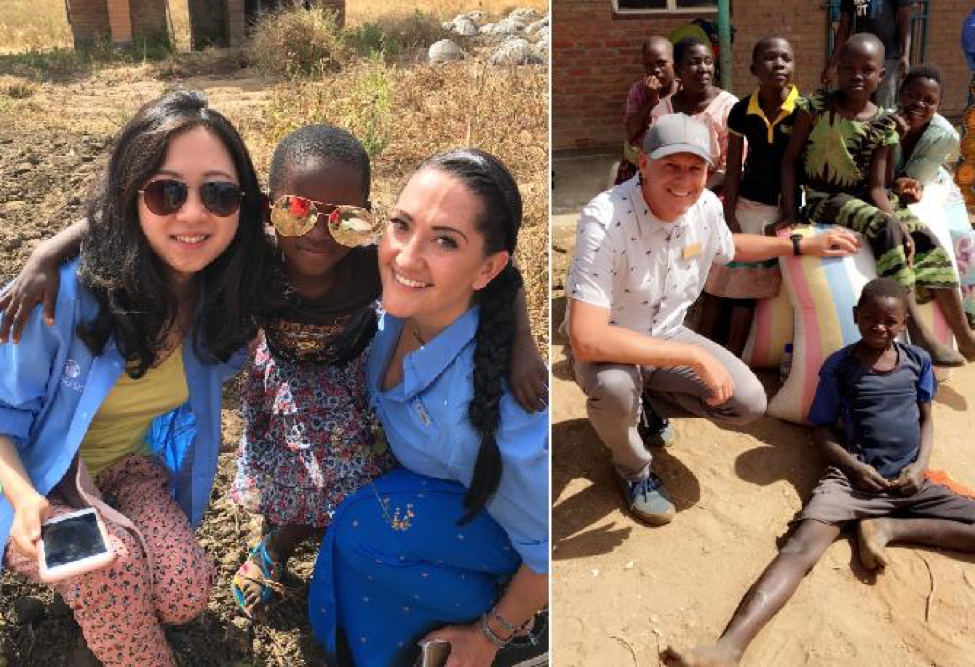 Nu Skin sales leaders and employees pose for a picture with Malawi children.
